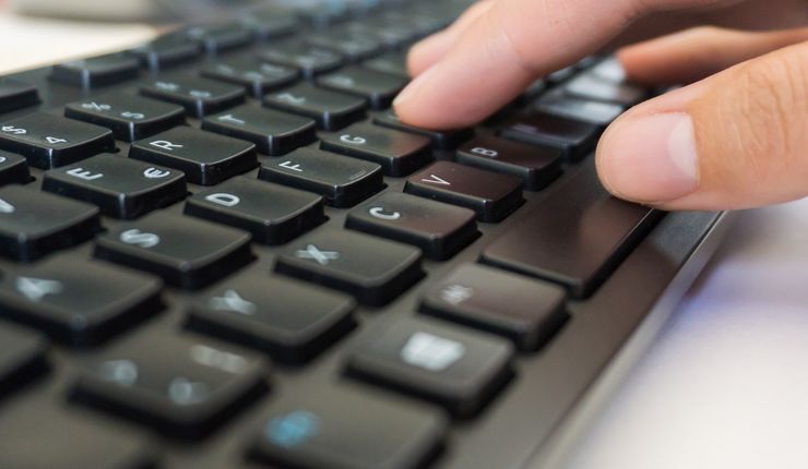 Eine Hand berührt eine Tastatur, Foto: Katarina Werneburg