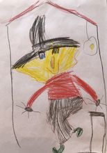 Valeska (6 Jahre) malt mit Buntstiften eine Hexe in ihrem Haus.